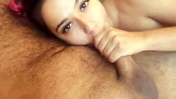 Amateur Latina gives a sensual blowjob while her partner watches TV