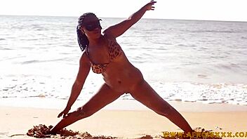 A voluptuous ebony beauty shakes her ample rear end on the seashore.