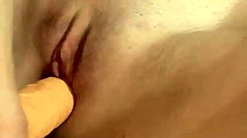 Stunning babe in lingerie and stockings teases with solo play action!