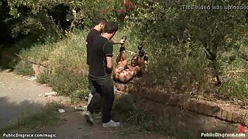 Bound brunette beauty experiences outdoor anal pleasure in BDSM encounter