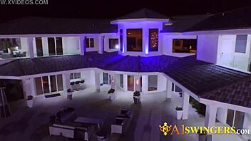 A swinger couple makes a steamy entrance at the mansion's party, engaging in group activities