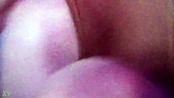 Softcore video of a girl giving a handjob on the couch