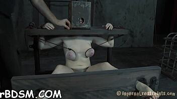 A slave is brutally penetrated by a fuck machine while being restrained.