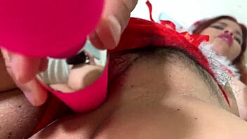 Asian teen in Santa outfit masturbates suggestively.