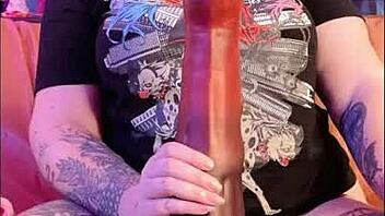 Unwrapping a massive toy: A tattooed MILF's experience