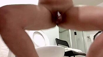 She cleans the toilet naked, showing her big tits and ass solo