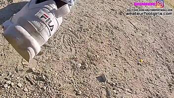 Foot fetish video features girl playing with sweaty Fila sneakers and nylons