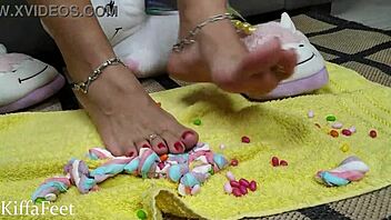 Kiffa, the dominatrix queen, crushes candies and marshmallows in a fetish video that features foot worship, red nails, and food and object crush