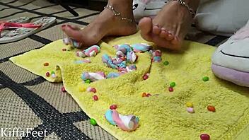 goddess kiffa crushes candies and marshmallows in foot fetish