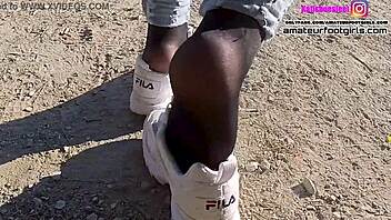 Foot fetish video features girl playing with sweaty Fila sneakers and nylons