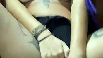 rasta woman splashing and playing in the bathtub