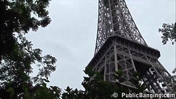 Two well-endowed men pleasure a lovely girl out in the open near the Eiffel Tower in Paris
