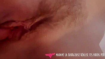 Amateur couple explores cunnilingus and vaginal stimulation in a cozy setting