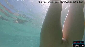 Clarise, a stunning Russian blonde model, disrobes in a pool for Playboy's viewing pleasure.