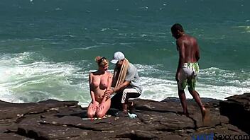 A stunning blonde with flawless large breasts enjoys a threesome, including anal sex, a big black cock, and a facial cumshot