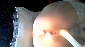 This submissive milf gets punished with candles in her pussy and ass