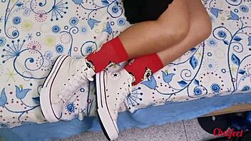 My girlfriend seduces me with her shoes and red socks, giving a footjob until I cum