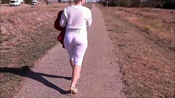 Crossdressing babe flaunts her big ass in white leggings outdoors