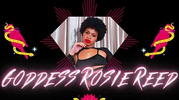 Rosie Reed, a dominant goddess, trains her submissive slave with nipple clamps in a POV video.