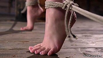 goth babe in hogtie suspension, suffering intensely