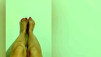 shy hottie with red pedicure shows off sexy legs for footjob on camera