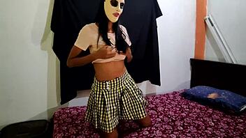 The brunette student dances sexily on the bed waiting for her boyfriend on halloween