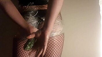 Fishnet babe shoves cucumber deep in juicy ass!