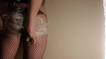 Fishnet babe shoves cucumber deep in juicy ass!