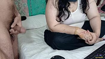 A cheating wife with big breasts performs a handjob on her friend's cock while rubbing his genitals in her armpit during a live webcam show