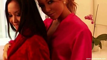 Exotic blonde and brunette lesbians kiss passionately while masturbating in an erotic scene