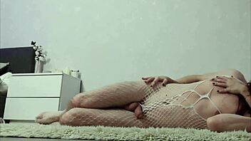 A couple engages in intimate poses on the carpet