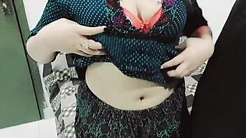 Desi stepmom undresses for husband and engages in sexual activity on sofa with Hindi audio