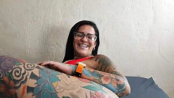 TATTOOED MILF RIDES MACHINE FOR INTENSE ORGASM.