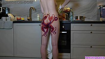 A barefoot woman with an octopus tattoo on her buttocks prepares dinner in the kitchen and disregards you