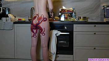 A barefoot woman with an octopus tattoo on her buttocks prepares dinner in the kitchen and disregards you