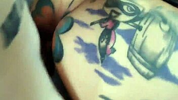 TATTOOED MILF RIDES MACHINE FOR INTENSE ORGASM.