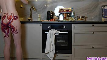 A barefoot woman with an octopus tattoo on her buttocks prepares dinner in the kitchen and disregards you
