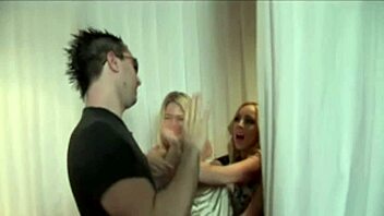 Uniformed women giving a handjob to a naked man