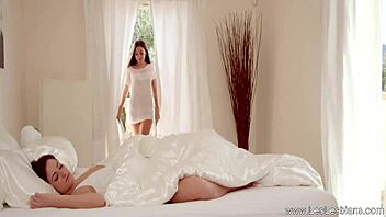 Two blonde milfs passionately kiss and finger each other in loving european embrace.