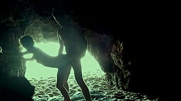 A couple's intimate encounter in a secluded beach cave