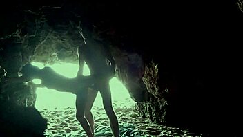 A couple's intimate encounter in a secluded beach cave
