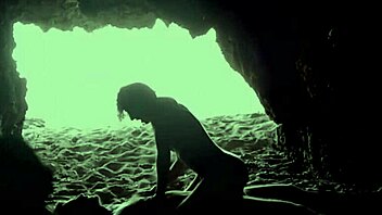 A couple's intimate encounter in a secluded beach cave