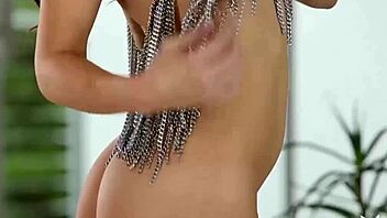 Gigi Marie, a stunning model with petite breasts, seductively undresses and poses in the nude
