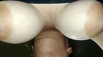 Milf with large breasts performs oral on a man