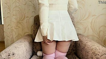 Girl in white skirt masturbating intensely with vibrator