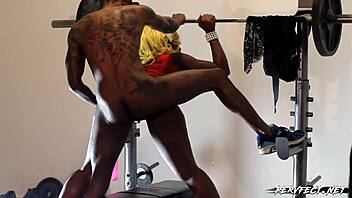 Couple Engages In Intense Weightroom Workout Session.
