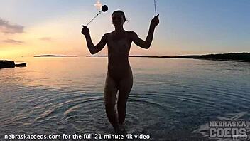 Look at this pretty nude fire dancing on the beach at sunset
