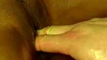 An asian babe gives an interracial blowjob while receiving a sensual massage and handjob from her lover