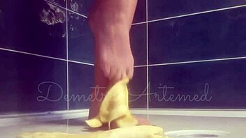 Banana crushing with bare feet in wild European fetish play.