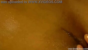 An asian babe gives an interracial blowjob while receiving a sensual massage and handjob from her lover